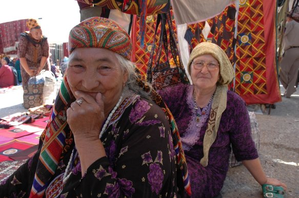 Photo shows to Turkmen women dressed in traditional outfits