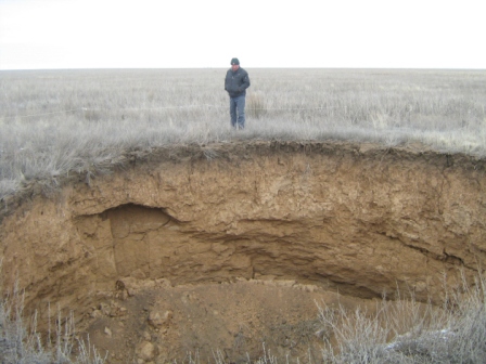 Fresh sinkhole near the village of Zhanatalap, diameter 10-12 meters, approximately 8-9 meters deep.