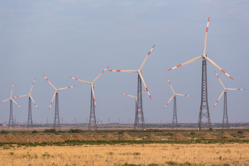 Wind generators in an open field, Azerbaijan. Adobe Stock.